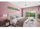 Elegant main bedroom with a slider, ceiling fan, and calming color scheme at 4351 Mallard Lake Dr, Spring Hill, FL 34609