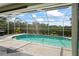 View of the pool and green landscape from the outdoor area at 4351 Mallard Lake Dr, Spring Hill, FL 34609