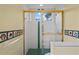 Bathroom shower showcasing glass doors, white tiling, and green accents at 4351 Mallard Lake Dr, Spring Hill, FL 34609