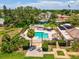 Aerial view of community pool with tiki huts and outdoor dining areas at 4567 Great Lakes S Dr, Clearwater, FL 33762