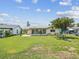 A beautiful backyard with lush green grass and a screened-in porch offers serene outdoor living at 4567 Great Lakes S Dr, Clearwater, FL 33762