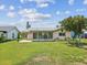 A beautiful backyard with lush green grass and a screened-in porch offers serene outdoor living at 4567 Great Lakes S Dr, Clearwater, FL 33762