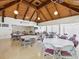 A community hall with vaulted wooden ceiling, bright lighting, tables, chairs, and American flag at 4567 Great Lakes S Dr, Clearwater, FL 33762
