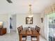 Bright dining room featuring a wooden table with seating and a decorative mirror at 4567 Great Lakes S Dr, Clearwater, FL 33762