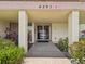An entrance to a community center with lush plantings, a concrete walkway, and prominent building number at 4567 Great Lakes S Dr, Clearwater, FL 33762