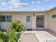 The front door and walkway with tiled landing are flanked by tropical vegetation at 4567 Great Lakes S Dr, Clearwater, FL 33762