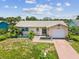 Charming single-story home featuring a one-car garage, tropical landscaping and lovely curb appeal at 4567 Great Lakes S Dr, Clearwater, FL 33762
