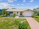 Charming single-story home featuring a one-car garage, tropical landscaping and lovely curb appeal at 4567 Great Lakes S Dr, Clearwater, FL 33762