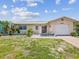 Charming single-story home featuring a one-car garage, tropical landscaping and lovely curb appeal at 4567 Great Lakes S Dr, Clearwater, FL 33762