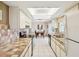 Bright kitchen with white cabinets, tile countertops, stainless steel appliances and a view into the dining room at 4567 Great Lakes S Dr, Clearwater, FL 33762