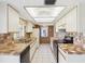 This is a kitchen with white cabinets, tile countertops, and stainless steel appliances at 4567 Great Lakes S Dr, Clearwater, FL 33762