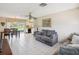 Open living room with tile floors leading to kitchen, dining room, and sliding door to yard at 4567 Great Lakes S Dr, Clearwater, FL 33762