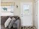 View of front door, windows, neutral paint, and access to closet and view into living spaces at 4567 Great Lakes S Dr, Clearwater, FL 33762