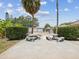 Community pool area with picnic tables and lush landscaping at 4567 Great Lakes S Dr, Clearwater, FL 33762