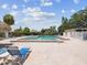 Outdoor pool with brick deck, surrounded by lush landscaping, providing a serene and private recreational space at 4567 Great Lakes S Dr, Clearwater, FL 33762
