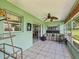 An inviting sunroom features tile floors, a ceiling fan, and a sliding door to the adjacent dining area at 4567 Great Lakes S Dr, Clearwater, FL 33762