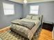 Inviting bedroom with soft blue walls, plush carpeting, and a comfortable queen-sized bed at 4628 Irene Loop, New Port Richey, FL 34652