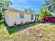 Charming single-story home featuring well-maintained landscaping and a red car in the driveway at 4628 Irene Loop, New Port Richey, FL 34652