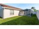 Backyard features a screened-in pool area, perfect for relaxing and entertaining outdoors at 4752 Weasel Dr, New Port Richey, FL 34653