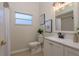 Clean bathroom features a stylish vanity, framed botanical art, and a window for natural light at 4752 Weasel Dr, New Port Richey, FL 34653