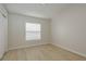 Neutral bedroom featuring light wood flooring, a window with blinds, and fresh paint at 4752 Weasel Dr, New Port Richey, FL 34653