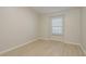 Bright bedroom featuring neutral walls, light wood flooring, and a window providing natural light at 4752 Weasel Dr, New Port Richey, FL 34653