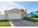 Single-story home featuring a well-maintained lawn, two-car garage and a charming entrance at 4752 Weasel Dr, New Port Richey, FL 34653