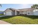 Charming single-story home featuring a well-maintained lawn and a two-car garage at 4752 Weasel Dr, New Port Richey, FL 34653