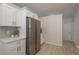 Bright kitchen featuring white cabinets, stainless steel refrigerator and stainless steel appliances at 4752 Weasel Dr, New Port Richey, FL 34653