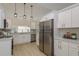 Modern kitchen featuring stainless steel appliances, white cabinets, and stylish pendant lighting at 4752 Weasel Dr, New Port Richey, FL 34653