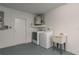 Functional laundry room with washer, dryer, utility sink, and water heater for convenience at 4752 Weasel Dr, New Port Richey, FL 34653