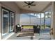 Enclosed patio with ceiling fan and cozy seating area offering a relaxing outdoor space at 4752 Weasel Dr, New Port Richey, FL 34653