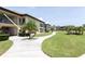 Well-kept condo building with lush lawns and walking path, providing a relaxed outdoor ambiance at 4754 Marine Pkwy # 103, New Port Richey, FL 34652