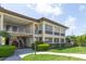 Well-maintained condo building with manicured landscaping and a convenient stairway entrance at 4754 Marine Pkwy # 103, New Port Richey, FL 34652