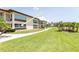 Charming condo with manicured lawns and inviting walkway creating a tranquil and welcoming atmosphere at 4754 Marine Pkwy # 103, New Port Richey, FL 34652