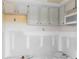 Partially renovated kitchen featuring white cabinets, perfect for customization at 4754 Marine Pkwy # 103, New Port Richey, FL 34652