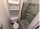 Compact bathroom featuring shower and shelving at 4853 Alcea St, New Port Richey, FL 34652