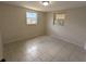 This bedroom features tile flooring and plenty of natural light from the windows at 4853 Alcea St, New Port Richey, FL 34652