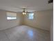 Bedroom featuring tile flooring, ceiling fan, and natural light at 4853 Alcea St, New Port Richey, FL 34652