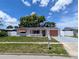 Quaint single story home with a white picket fence, charming details, and well-kept landscaping at 4853 Alcea St, New Port Richey, FL 34652