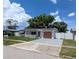 Delightful single story home featuring a white picket fence, colorful details, and well-kept landscaping at 4853 Alcea St, New Port Richey, FL 34652
