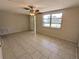 Bright living room featuring neutral walls, tile floors, and a ceiling fan for added comfort at 4853 Alcea St, New Port Richey, FL 34652