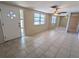 Bright living room featuring neutral walls, tile floors, and a ceiling fan for added comfort at 4853 Alcea St, New Port Richey, FL 34652