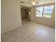 Open living room featuring tile floors and kitchen access with a window view at 4853 Alcea St, New Port Richey, FL 34652