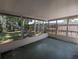 Spacious screened porch with views of the backyard and wood fence offers relaxing space and privacy at 4853 Alcea St, New Port Richey, FL 34652