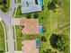 Aerial view highlighting a house with a private screened-in pool and landscaped yard at 5121 Delacroix Dr, Brooksville, FL 34604