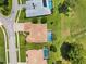 Overhead shot showing a house with a screened-in pool, complemented by green lawn at 5121 Delacroix Dr, Brooksville, FL 34604