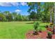Lush green backyard with manicured landscaping, offering a serene outdoor space at 5121 Delacroix Dr, Brooksville, FL 34604