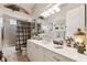 Bathroom featuring a vanity, framed mirror and cabinet with a tub and shower at 5121 Delacroix Dr, Brooksville, FL 34604