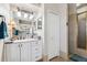 Bright bathroom features a walk-in shower with glass doors, and a large vanity with mirror at 5121 Delacroix Dr, Brooksville, FL 34604